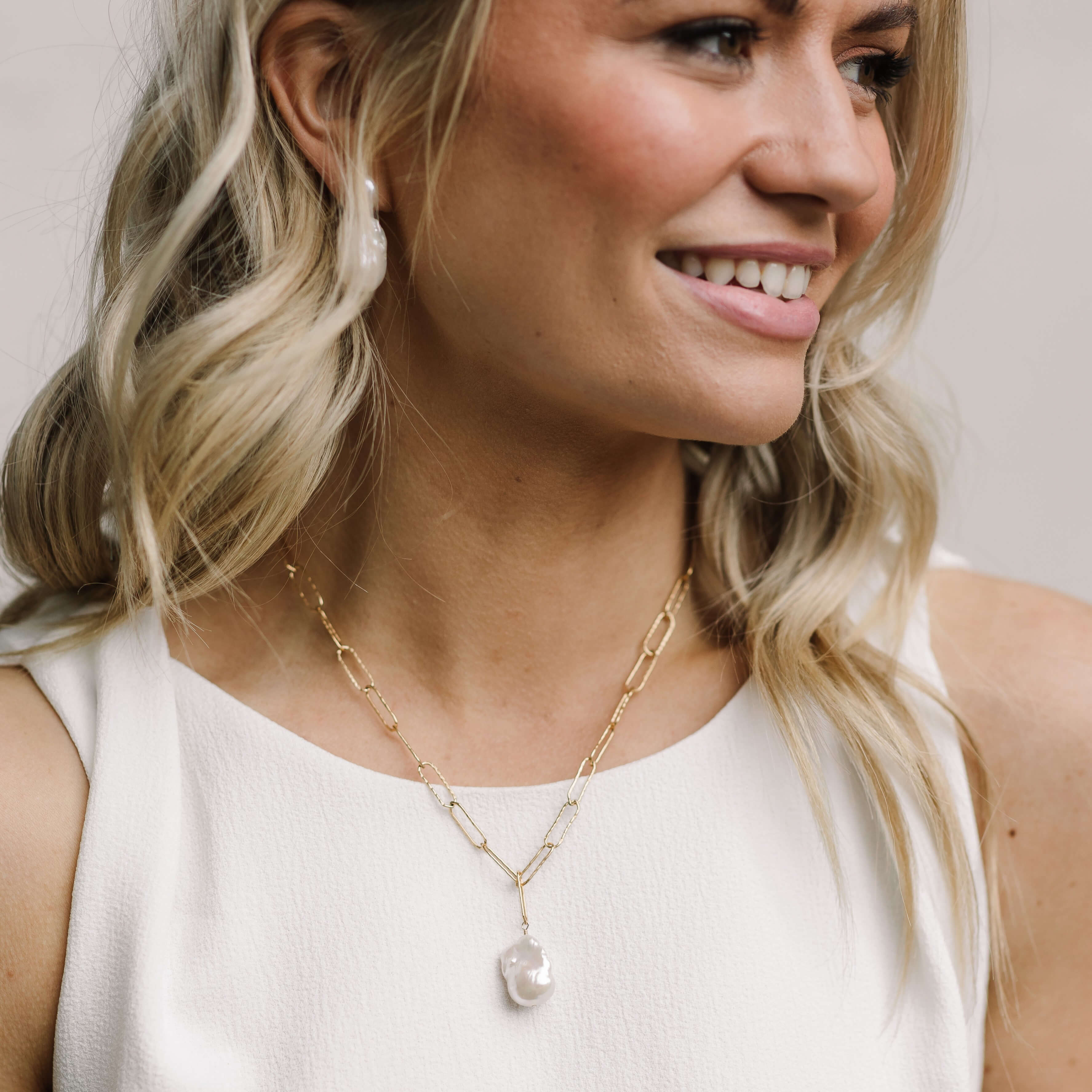 model wearing the paperclip chain necklace in gold