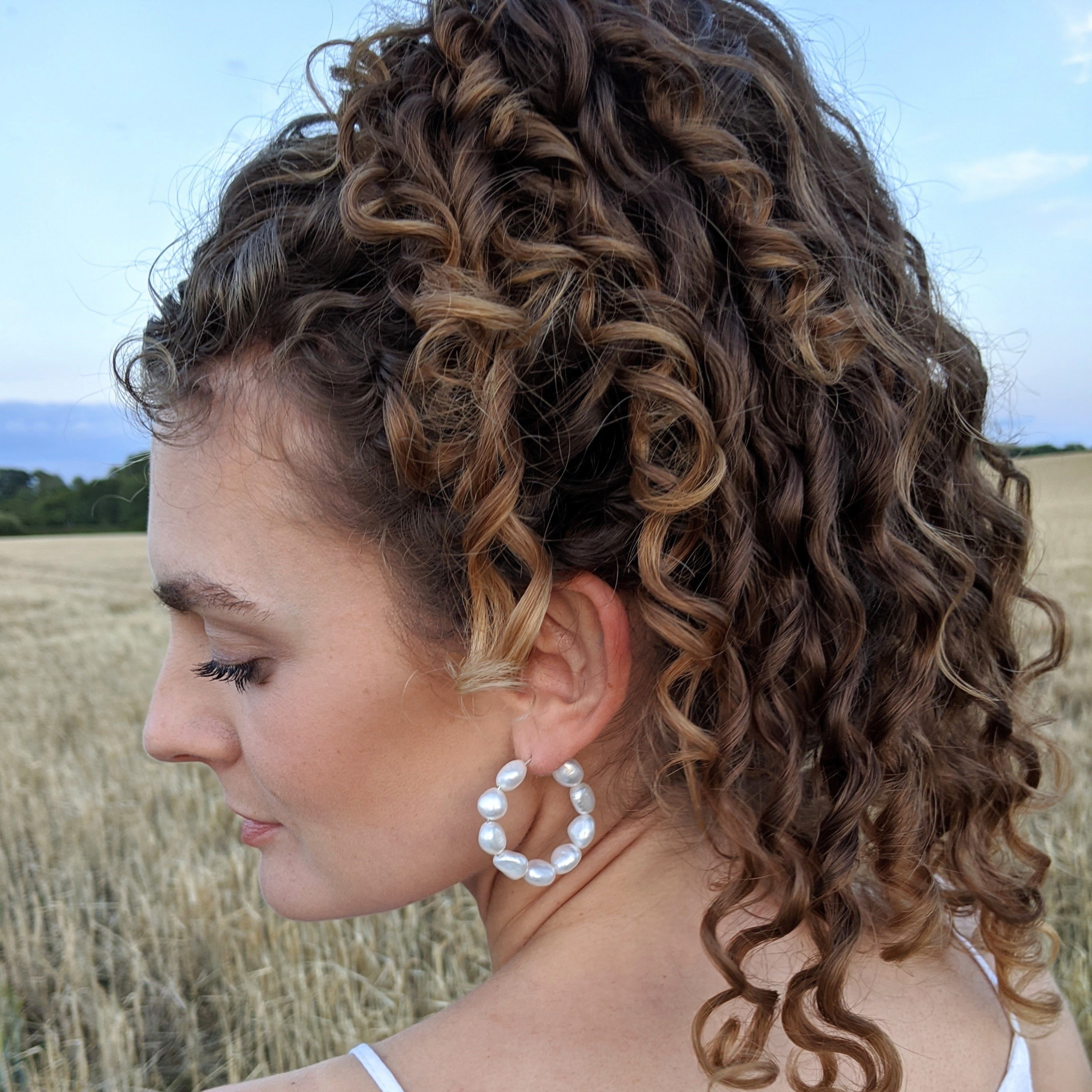 large pearl hoop earrings with nine 9mm baroque freshwater pearls model side
