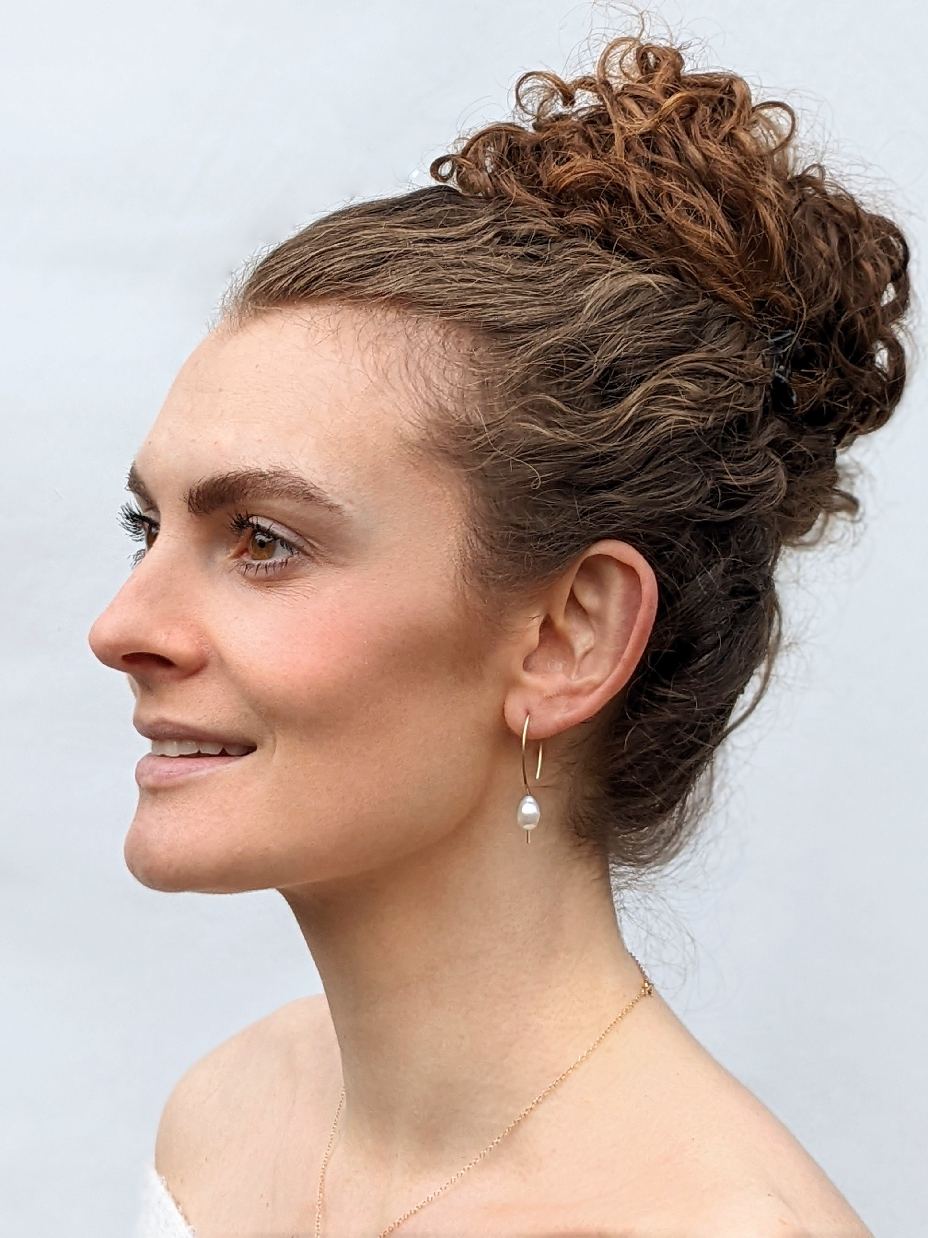 Headshot of model wearing gold filled baroque pearl earrings