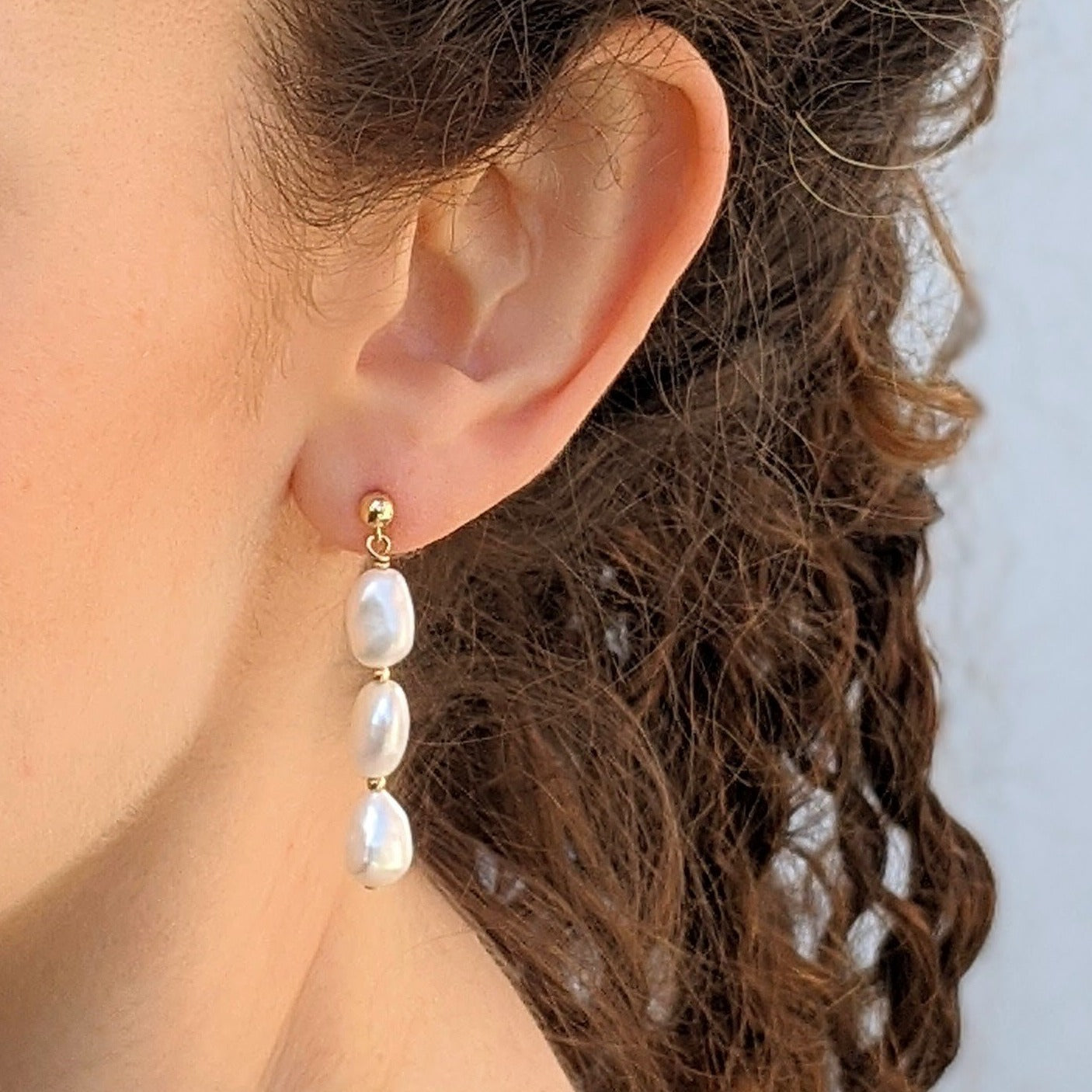 Pearl stud drop earrings model closeup