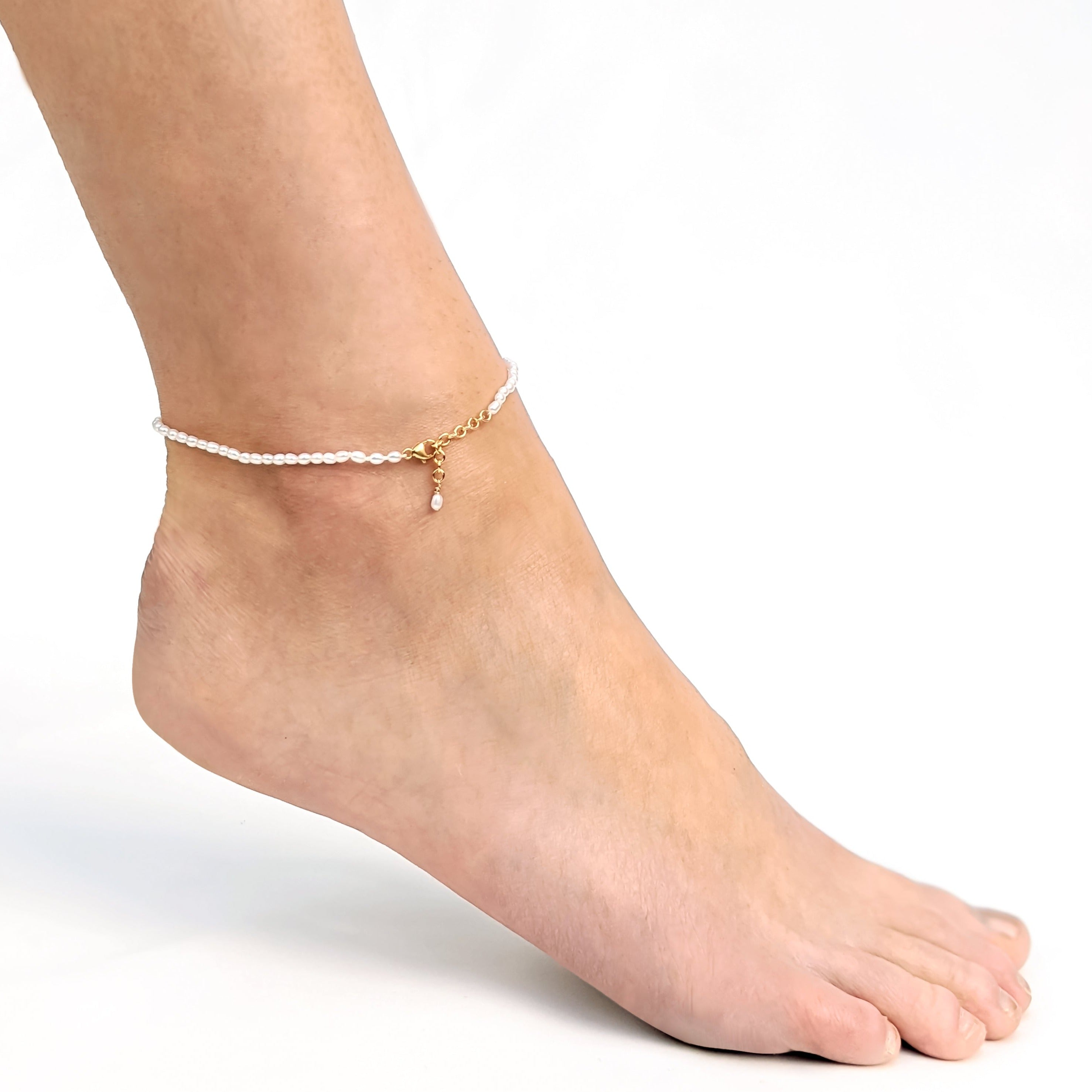 Tiny seed pearl anklet with gold adjustable clasp on ankle