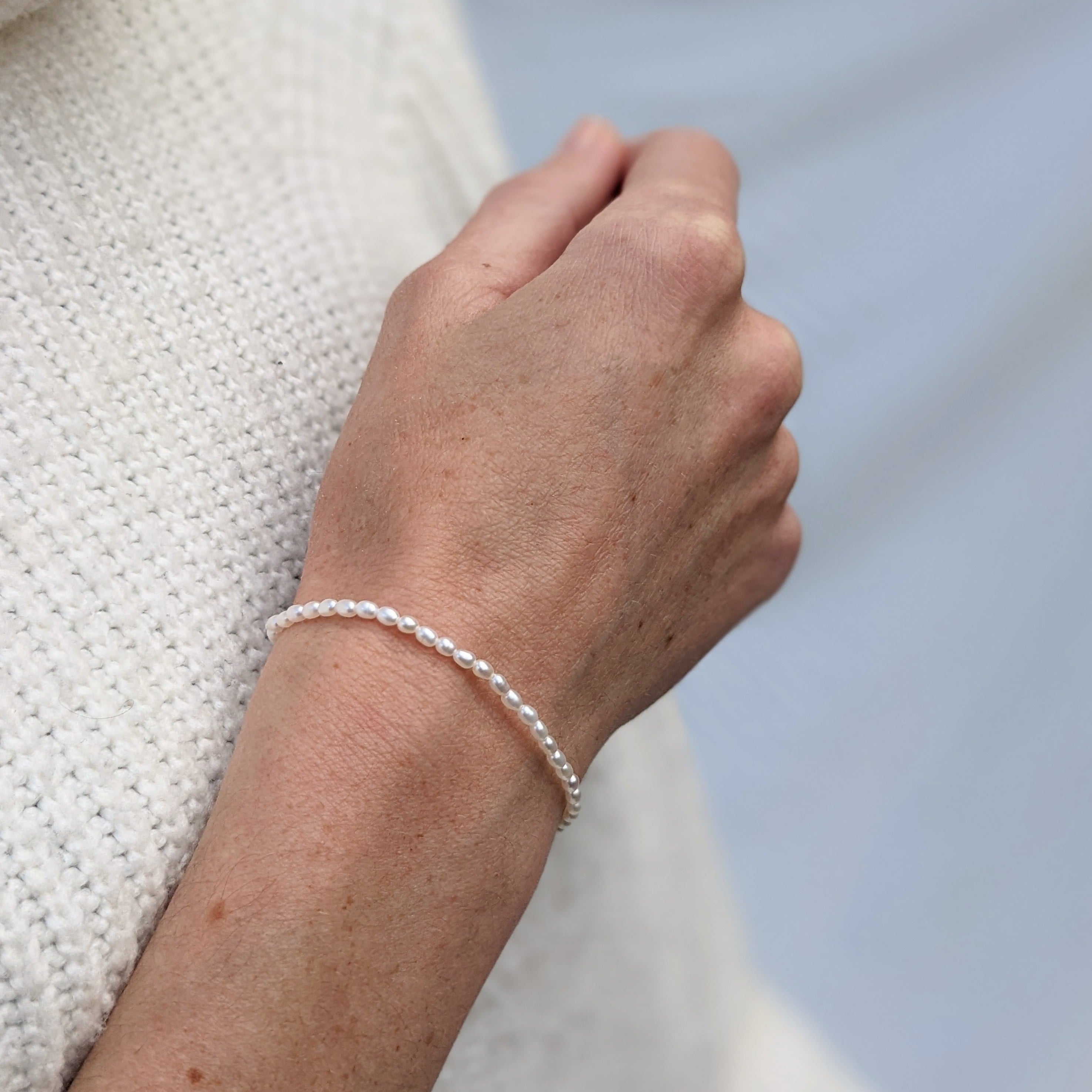 tiny seed pearl bracelet on a model