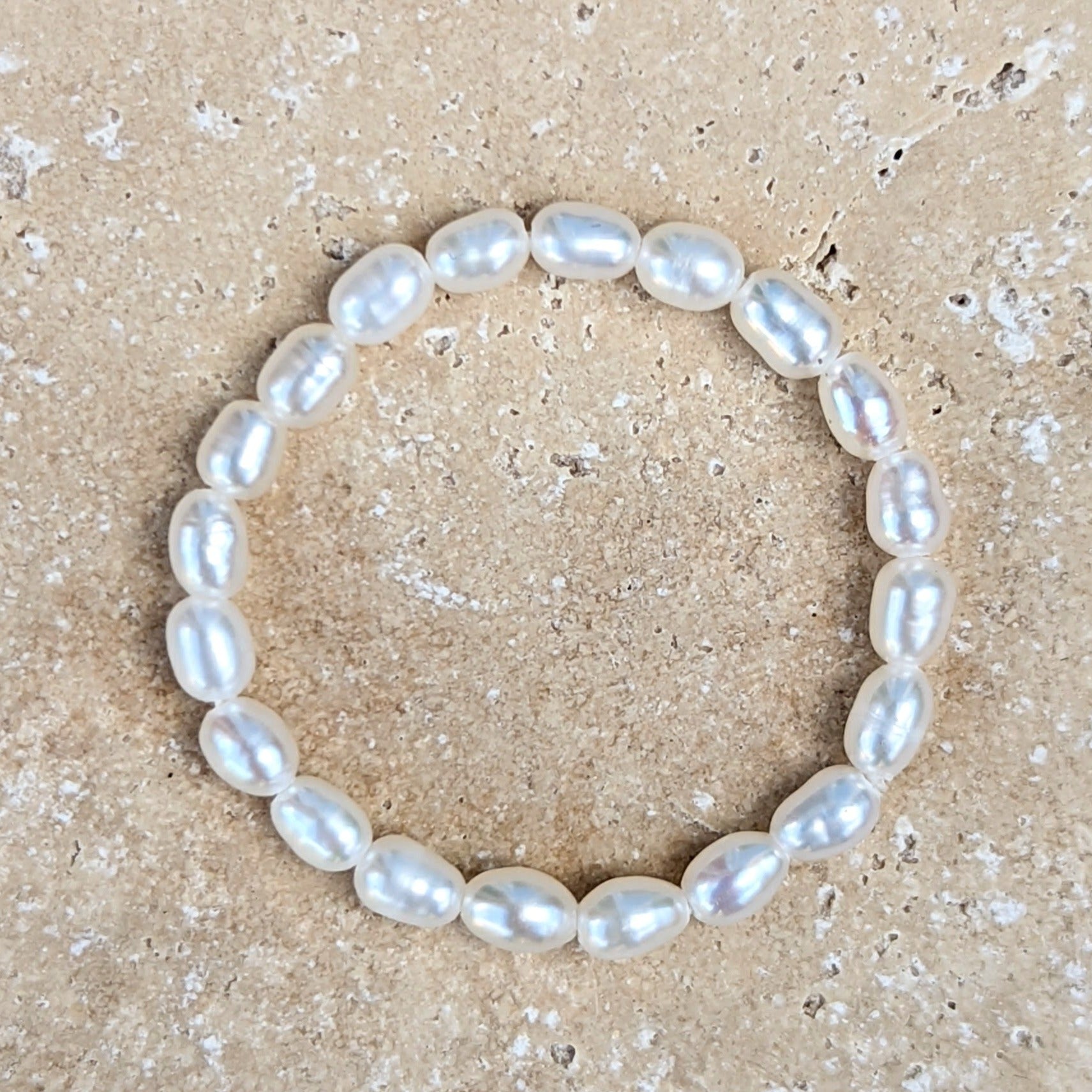 Seed pearl ring laid flat on tile