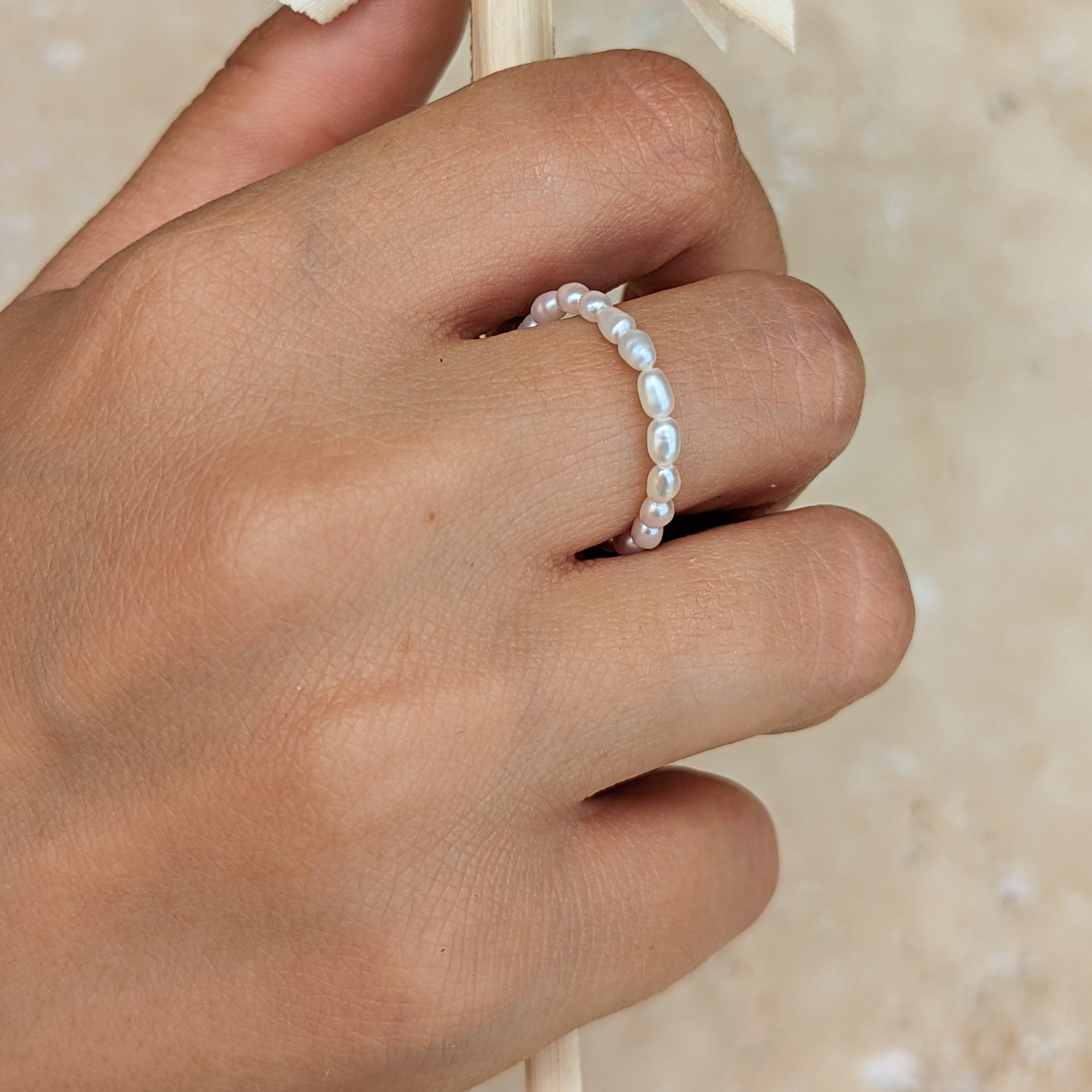 Hand with ring made of pearls