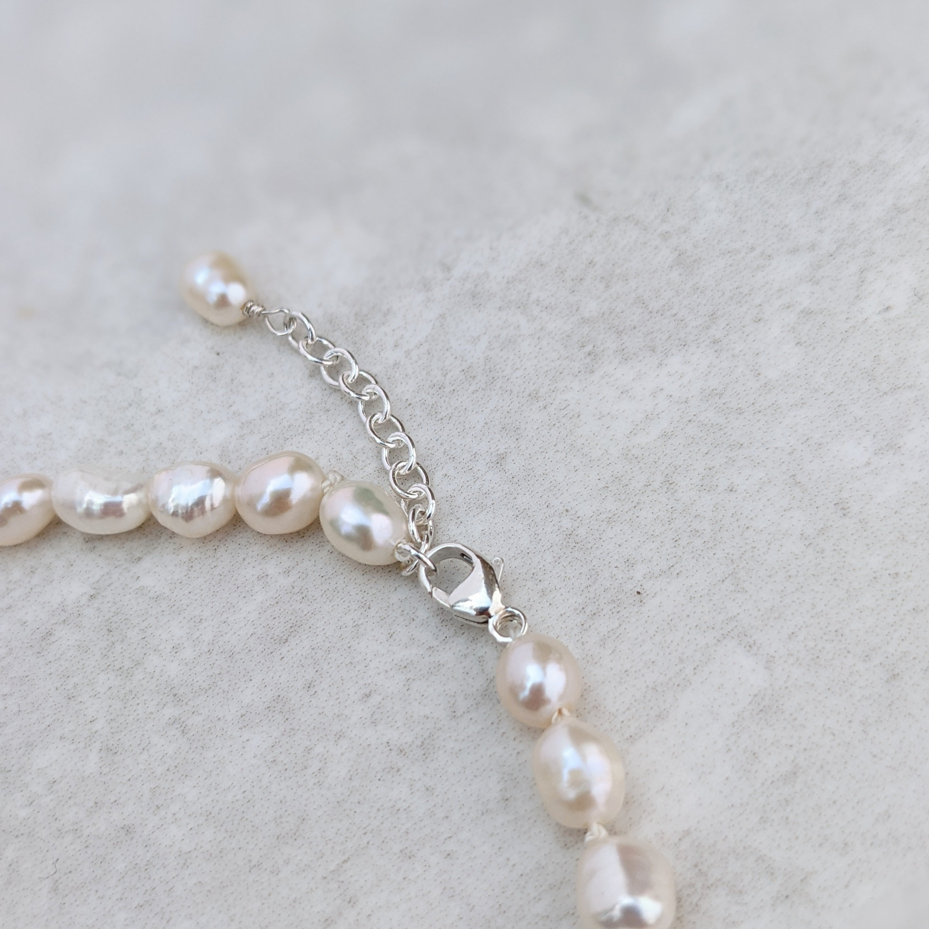 Closeup of the sterling silver clasp on a baroque pearl anklet