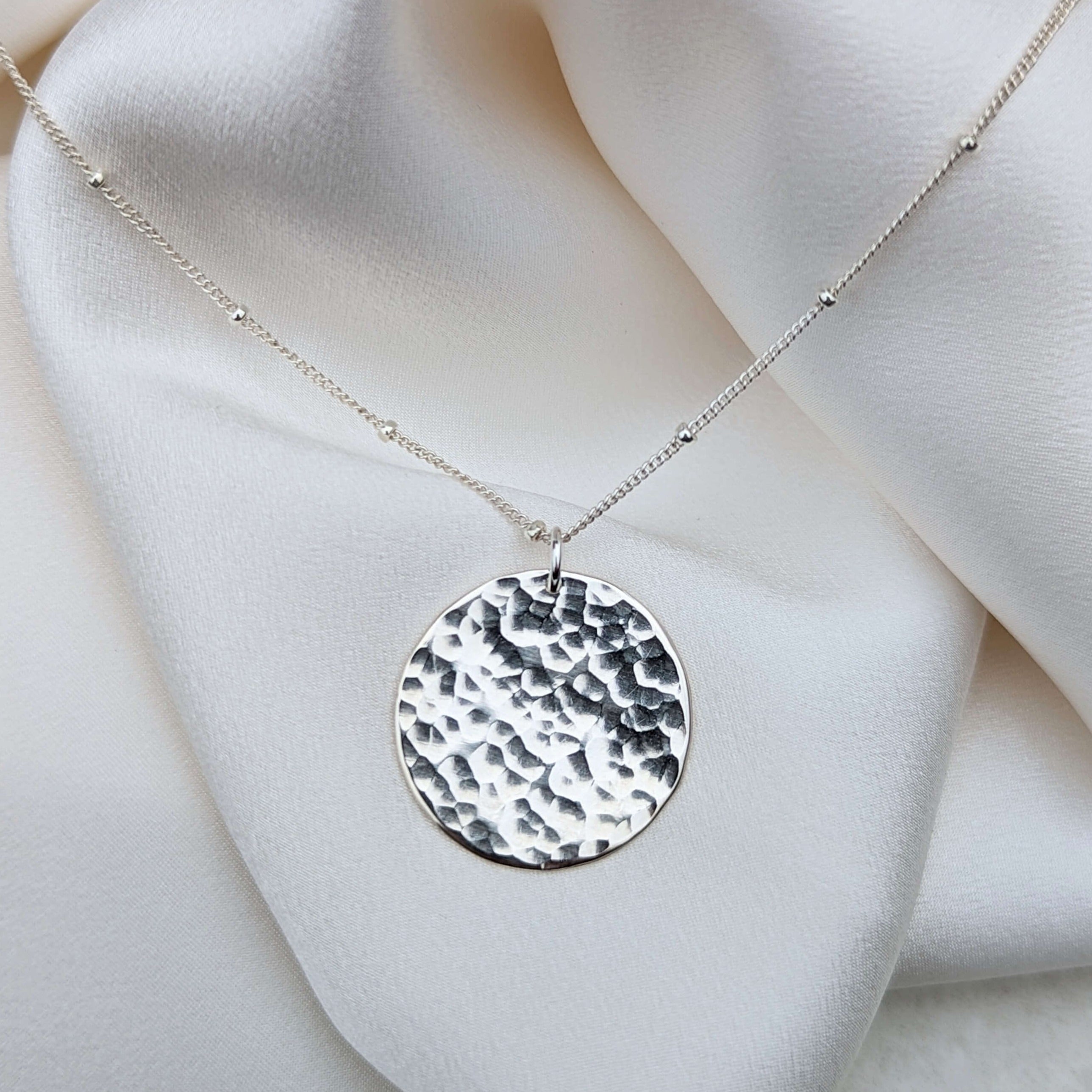 Sterling silver hammered disc pendant on satellite chain