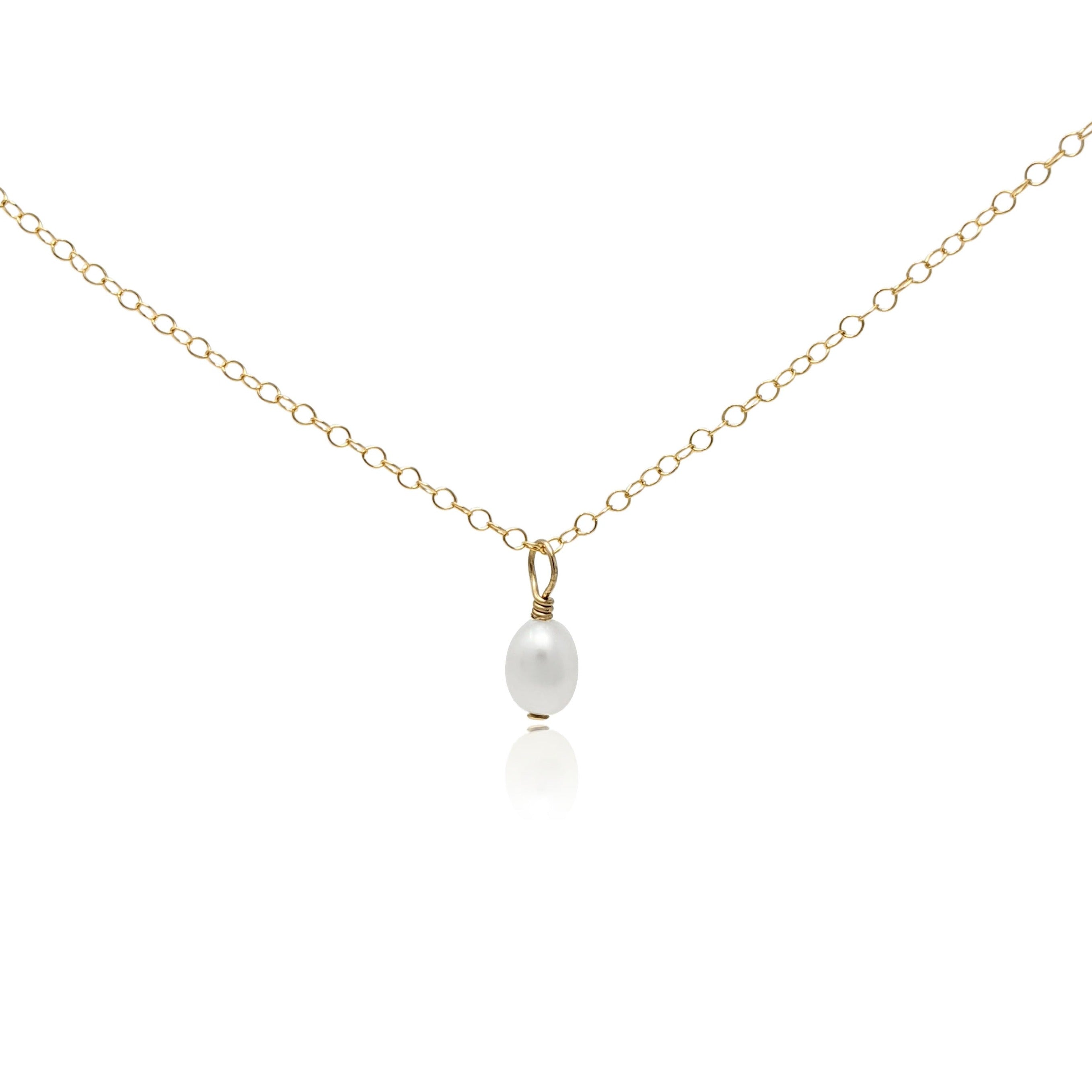 Small baroque pearl hanging as a pendant on a gold necklace