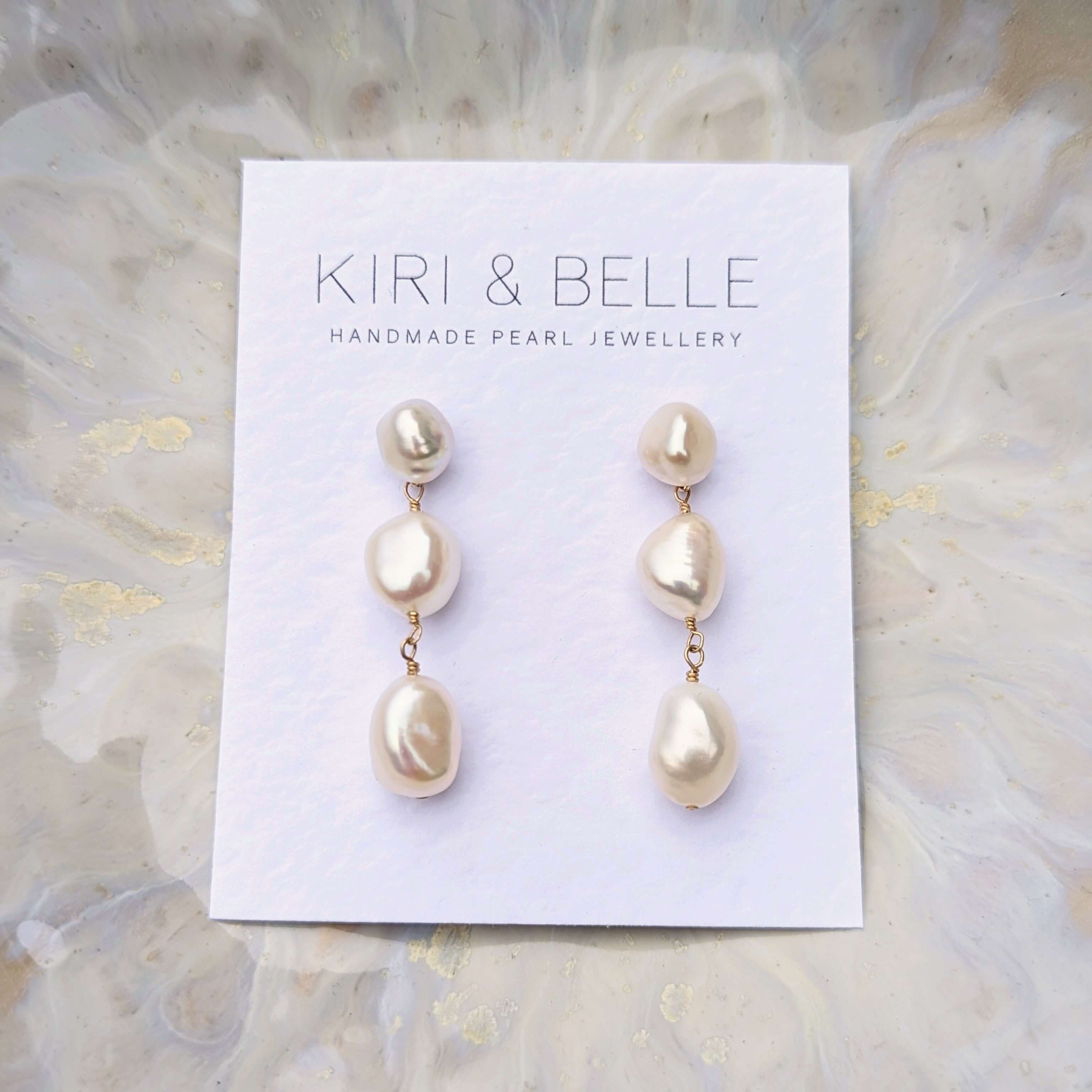 Three pearl drop earrings in gold filled on a white card