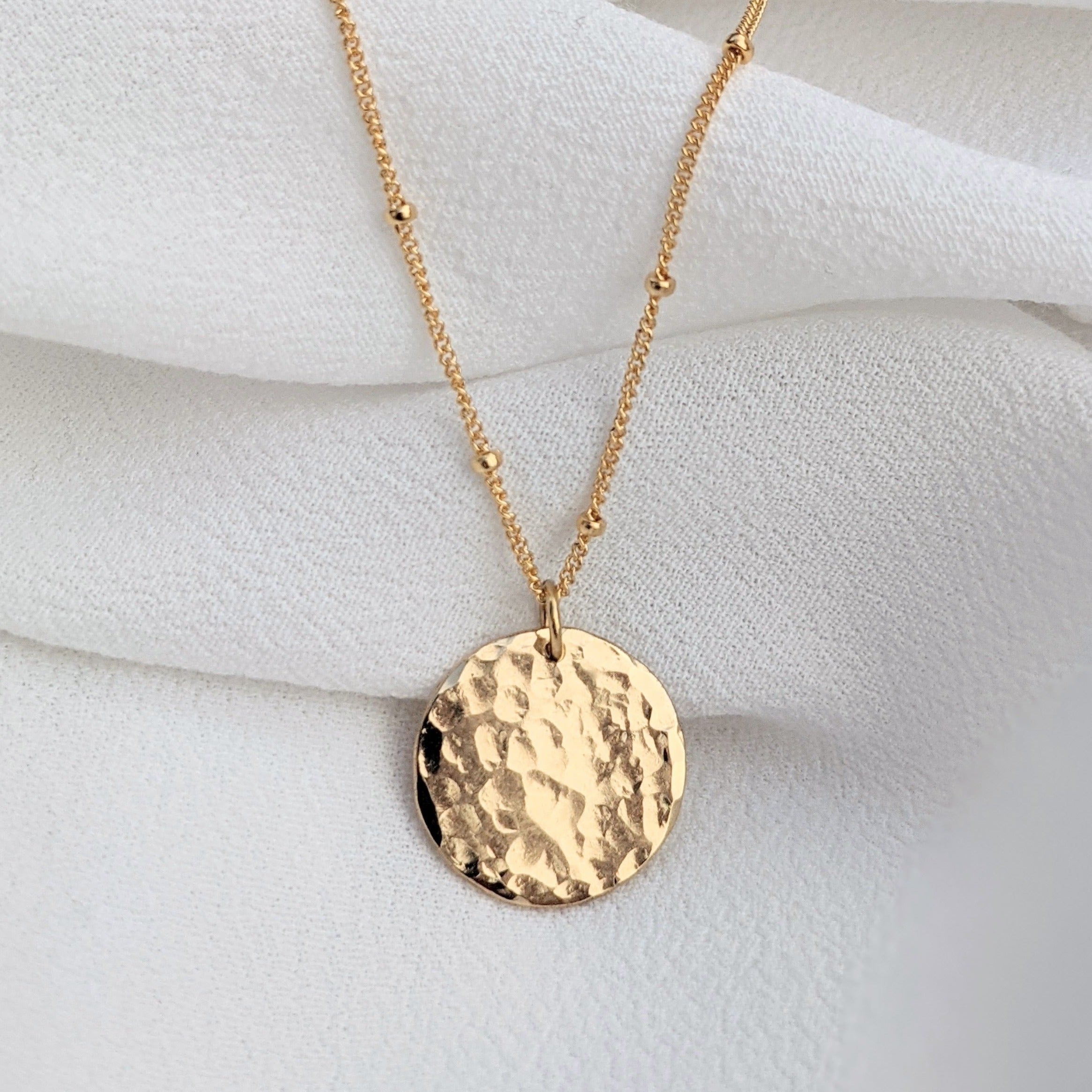 Small gold filled hammered disc pendant necklace on satellite chain